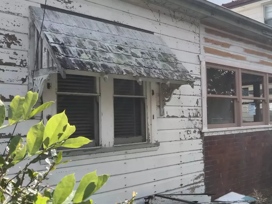 Weathered timber house exterior before preparation and painting