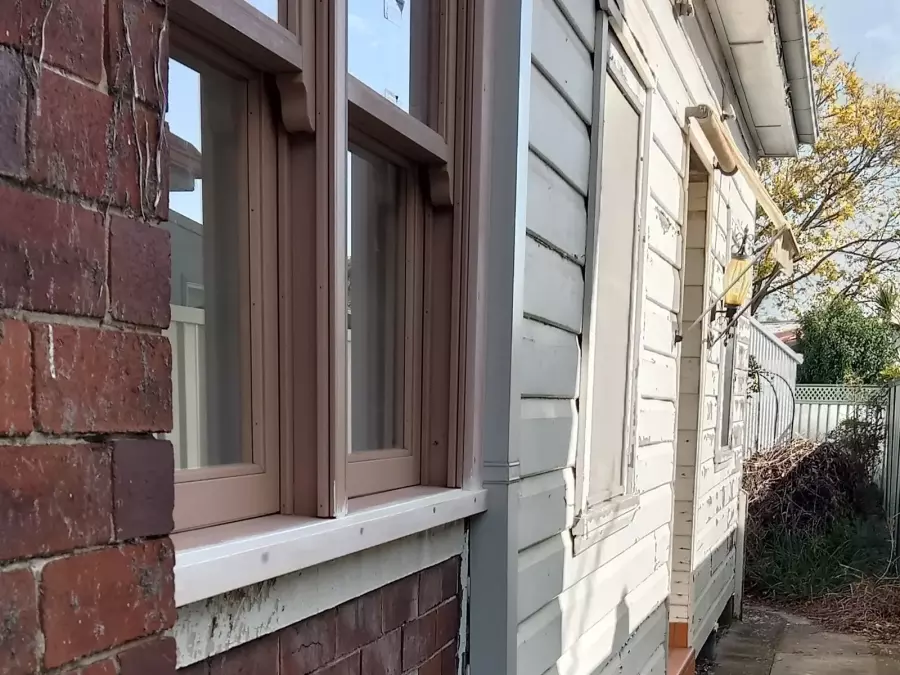 Side of weathered timber house before exterior painting