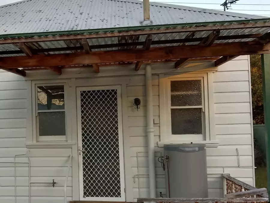 Rear entrance after exterior preparation and painting