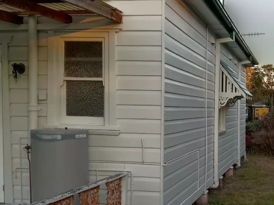 Side and rear of timber house after exterior painting