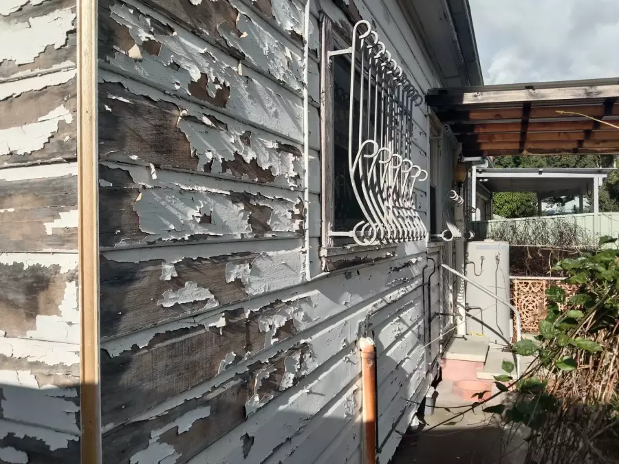Peeling timber wall and window before exterior restoration